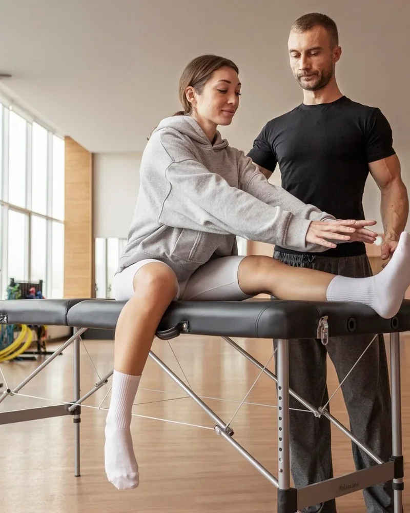 Doctor of Physical Therapy coaching a patient through post surgical strengthening