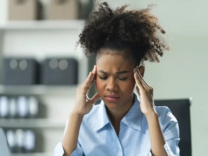 Doctor of Physical Therapy examining upper neck joints during a headache assessment in Sachse